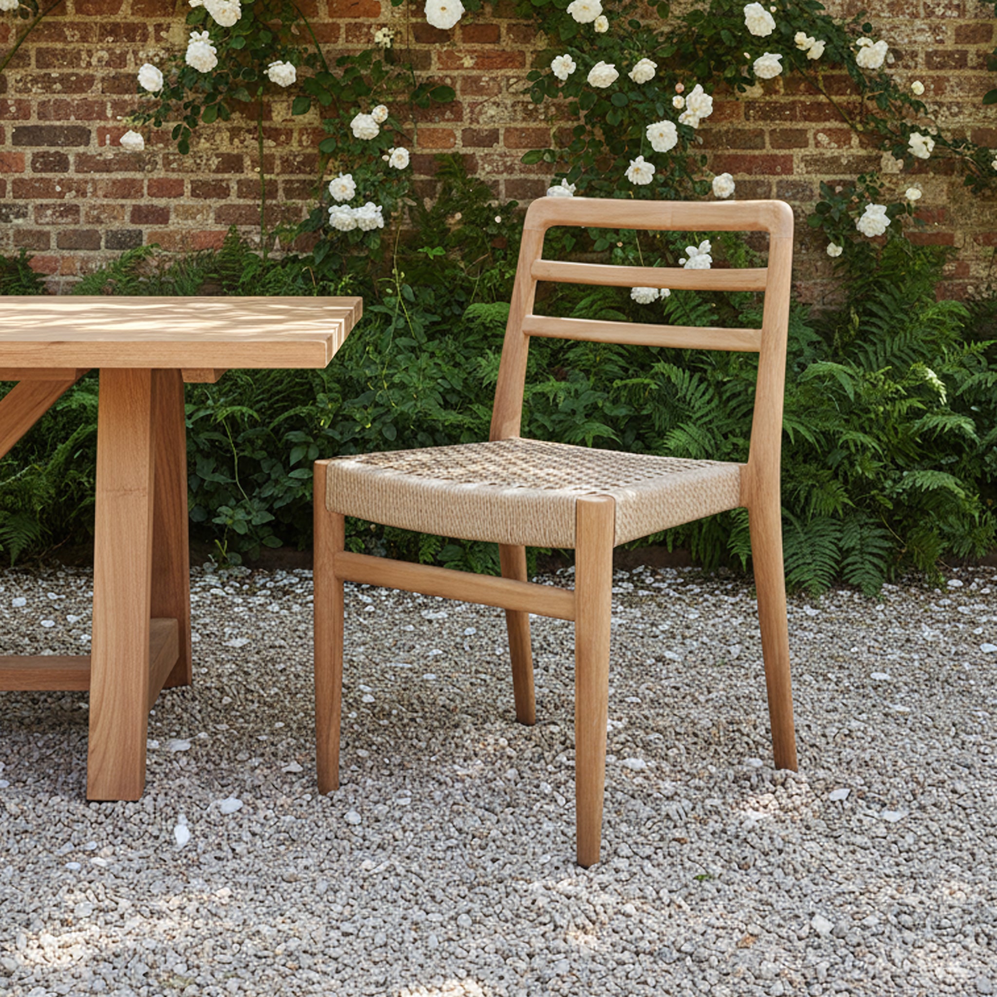 Pair of Raw Materials Verano teak dining chairs with armrests, showcasing sleek wooden design and comfortable seating for dining rooms.