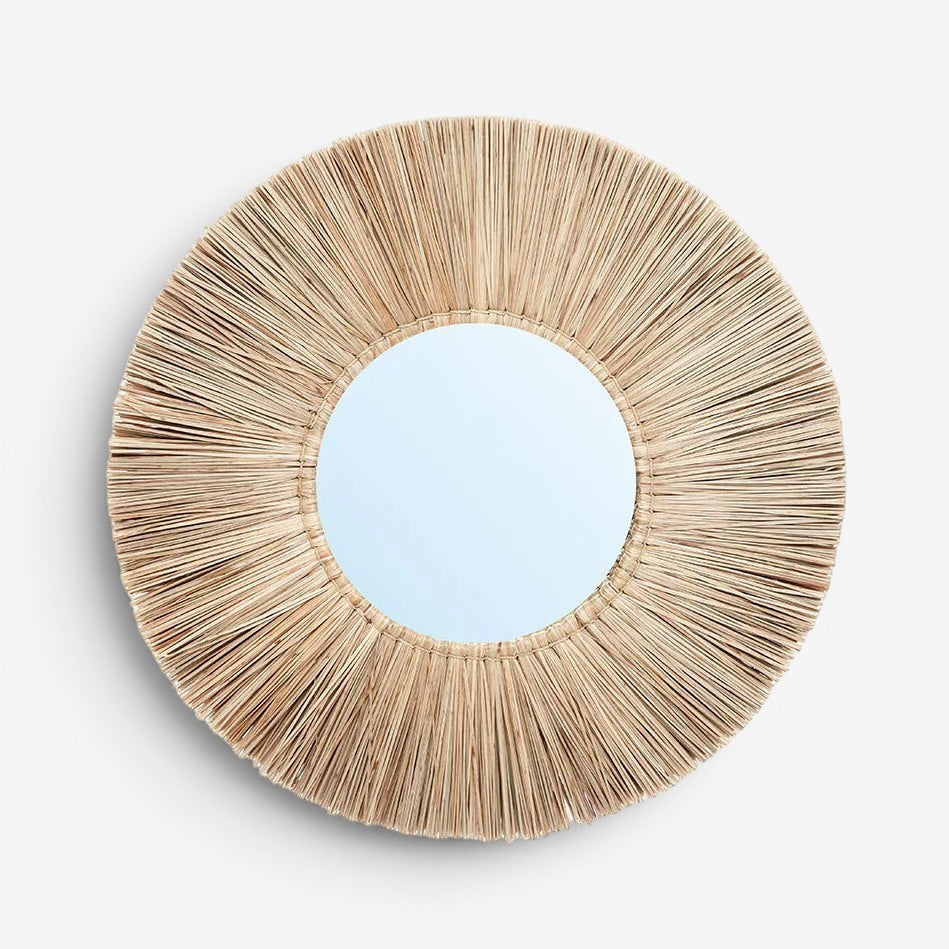 Kayu Living Alang Alang round mirror with natural grass fringe and central reflective glass. Boho coastal wall decor.