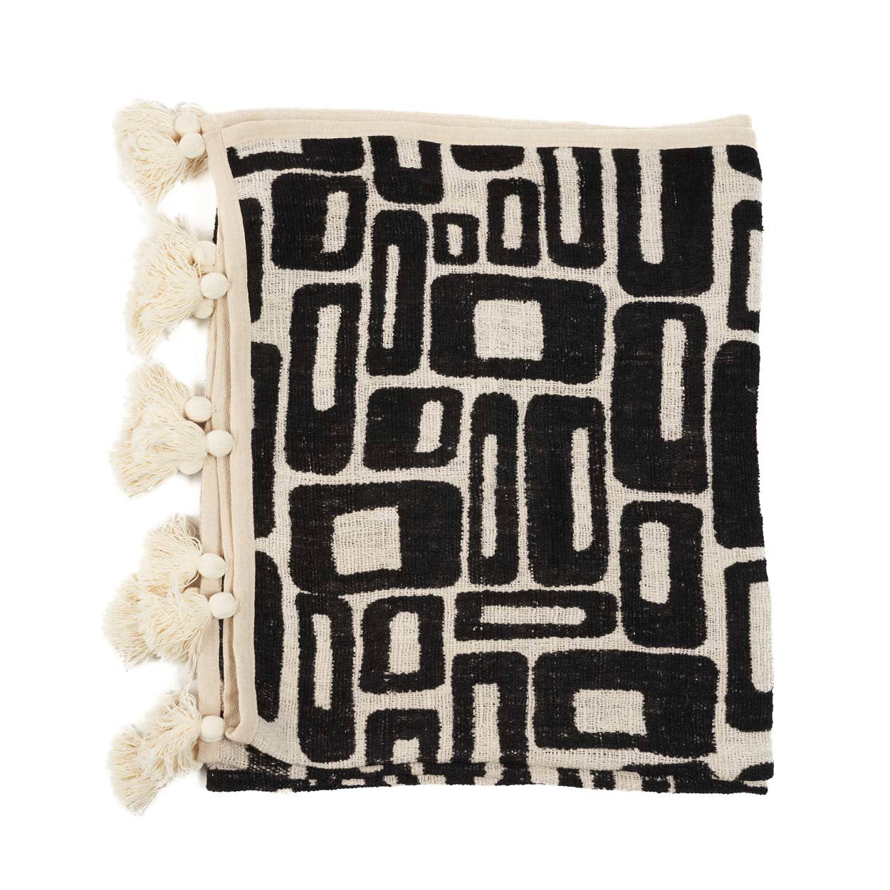 Kayu Living Aztec-pattern cotton bed throw in natural black with decorative tassels and woven geometric design.
