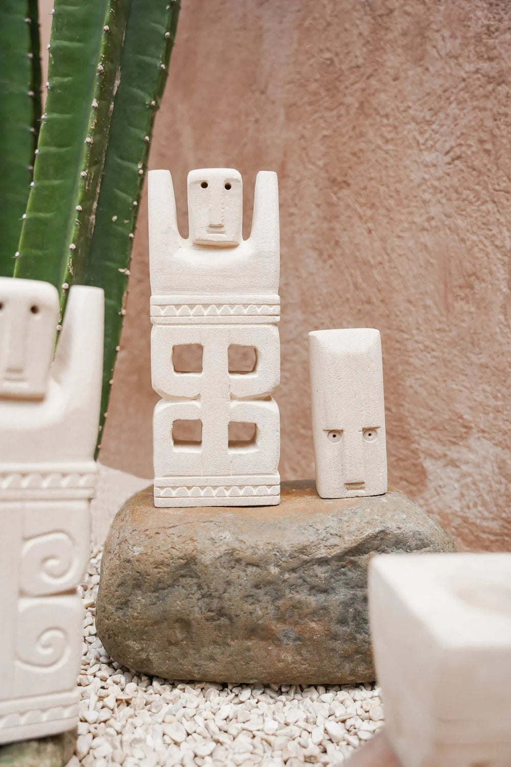 Kayu Living handcrafted Balinese stone figurines featuring traditional guardian designs with natural textured finish.