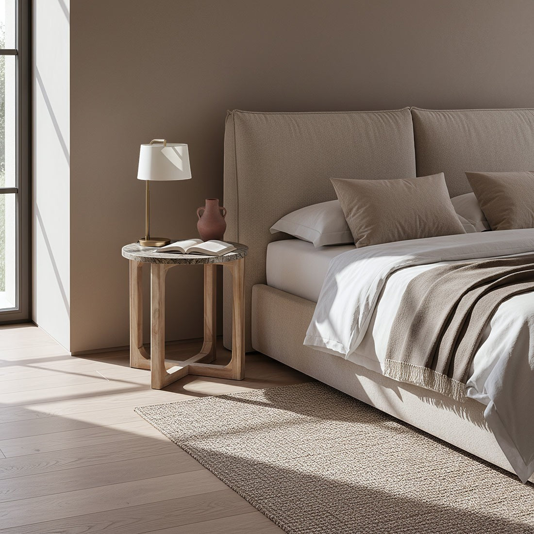 Kayu Living Bizar marble side table with rust-brown and green veins on a crossed mango wood base next to a bed.