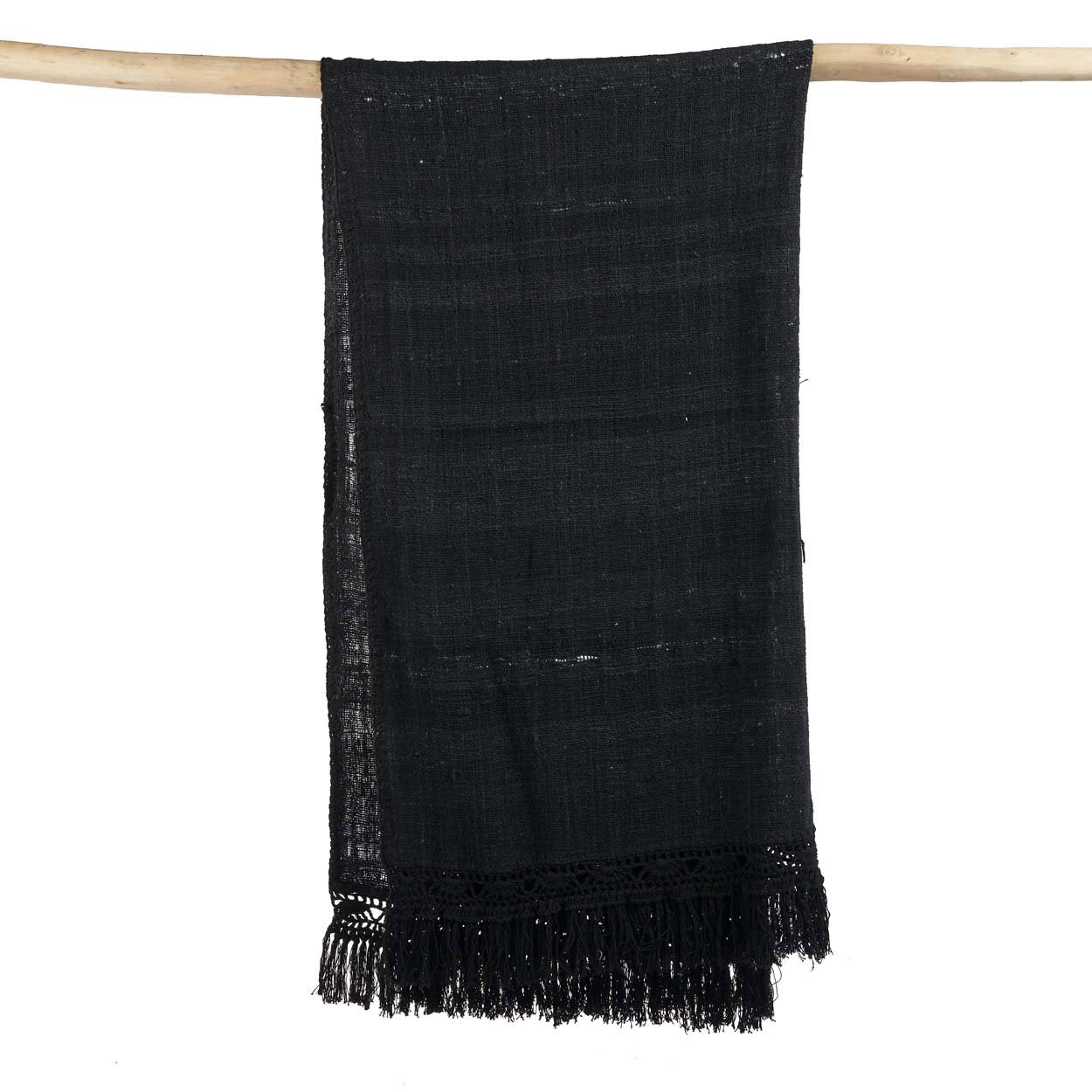 Kayu Living black cotton Gypsy bed throw with bohemian fringe detail hanging on a wooden rod