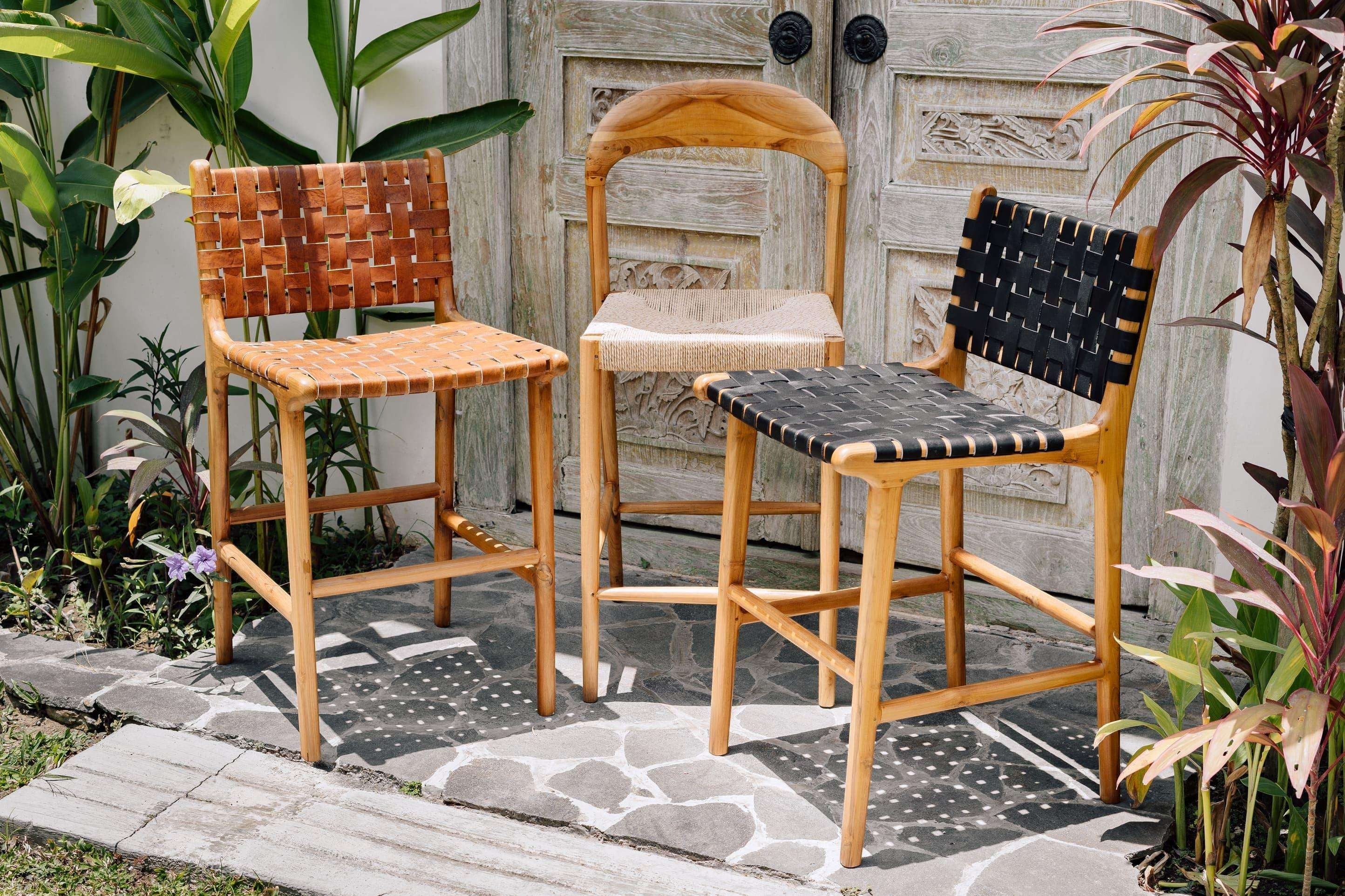 Kayu Living Umalas black woven leather counter stool with teak frame. Modern artisanal design for kitchen or bar.