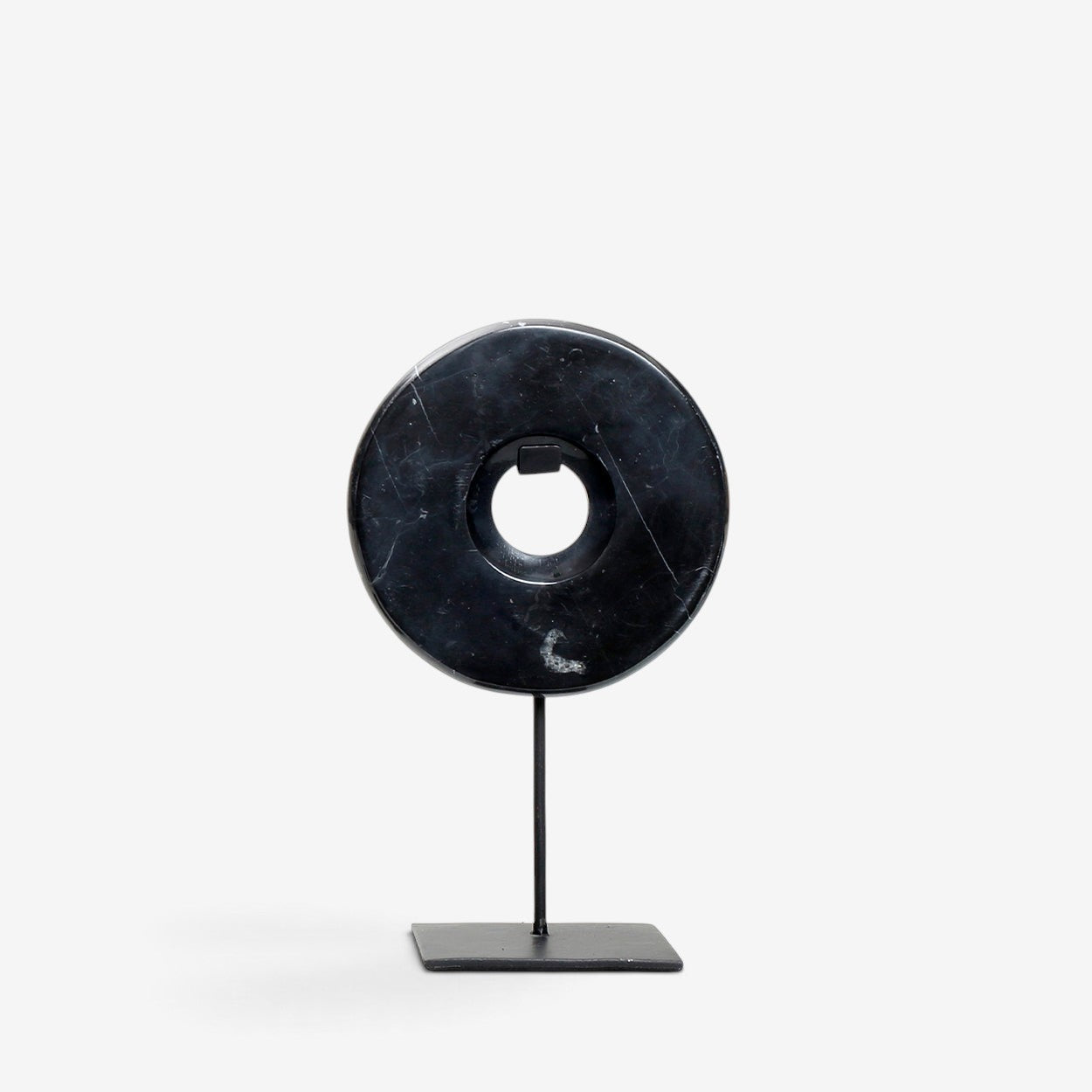 Kayu Living small black marble disc sculpture on a sleek metal stand, featuring natural veining for modern decor.