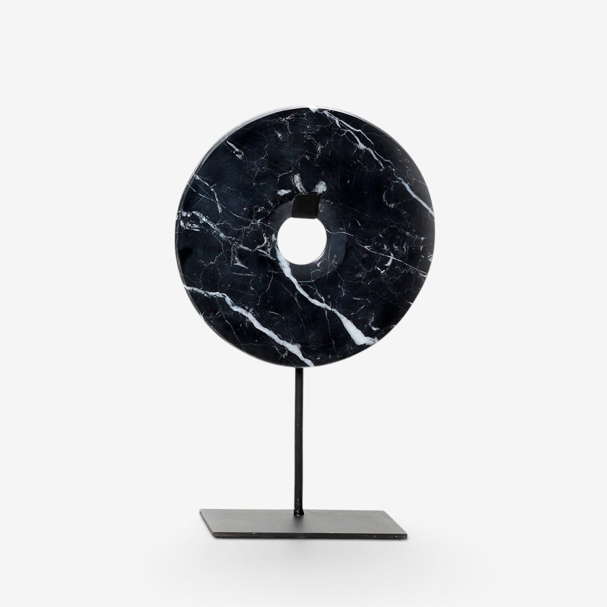 Kayu Living medium black marble disc sculpture with white veining on a minimalist black metal stand.