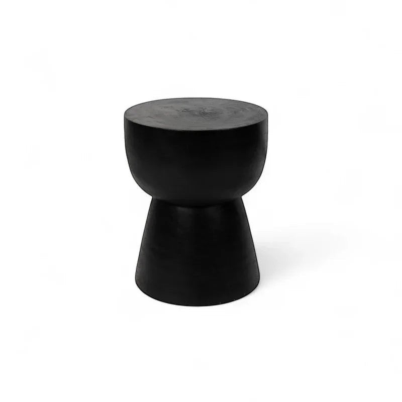 Kayu Living black solid suar wood cupped stool with hourglass shape and rustic charm.