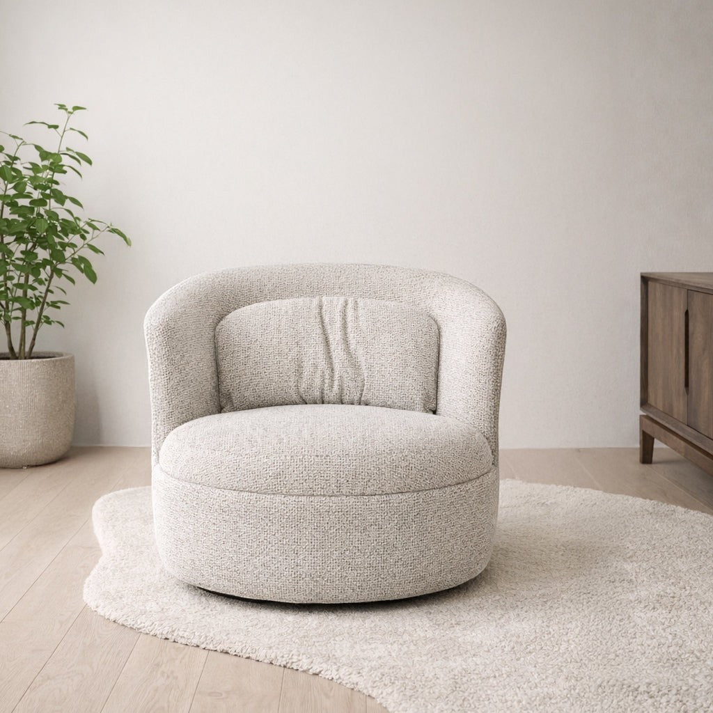 Kayu Living Britt swivel armchair in textured beige fabric with a rounded back and plush seat in a modern room