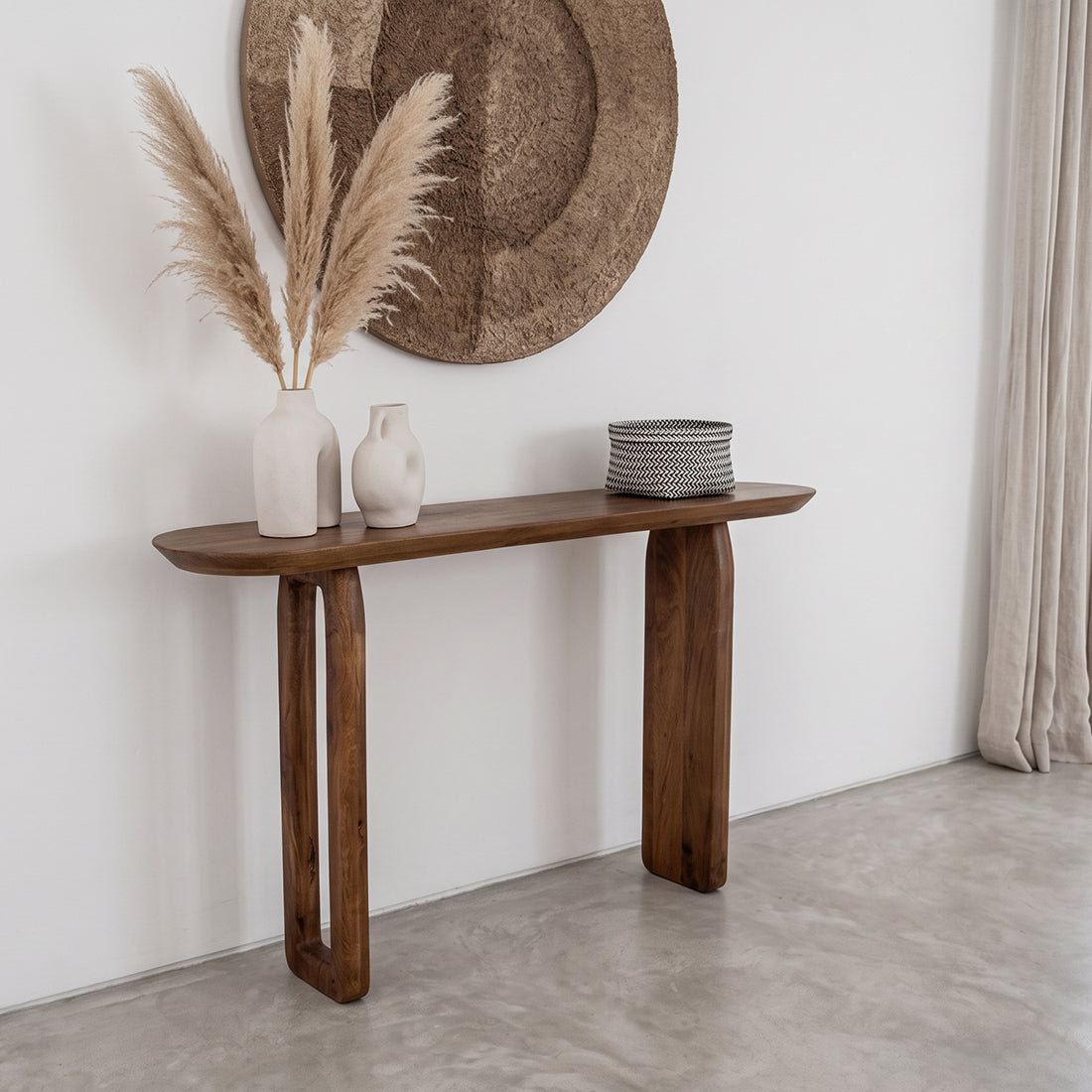 Kayu Living brown solid mango wood bullnose console table with rounded edges in a minimalist living room setting
