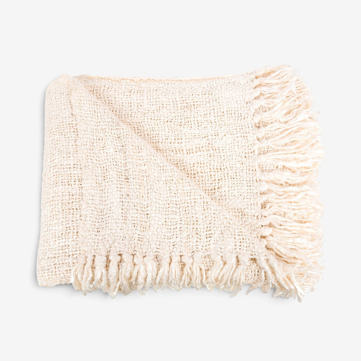 Kayu Living hand-woven cream cotton throw blanket with a waffled texture and decorative fringe edges.