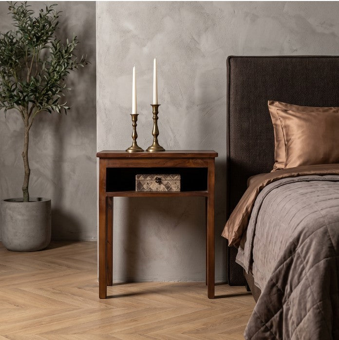 Kayu Living Factory bedside table in recycled wood with an open shelf, styled next to a bed with candles.