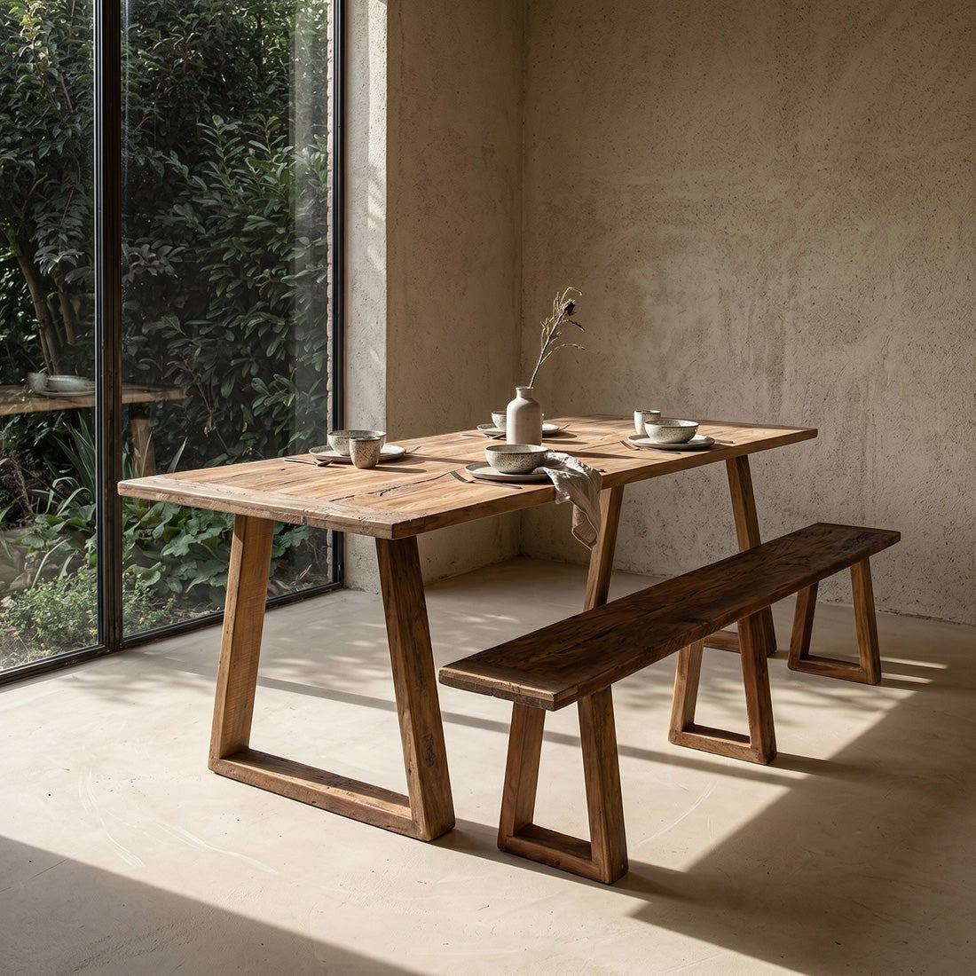 Kayu Living Farmwood dining table and matching bench in brown recycled wood with natural grain and knots in a sunlit room