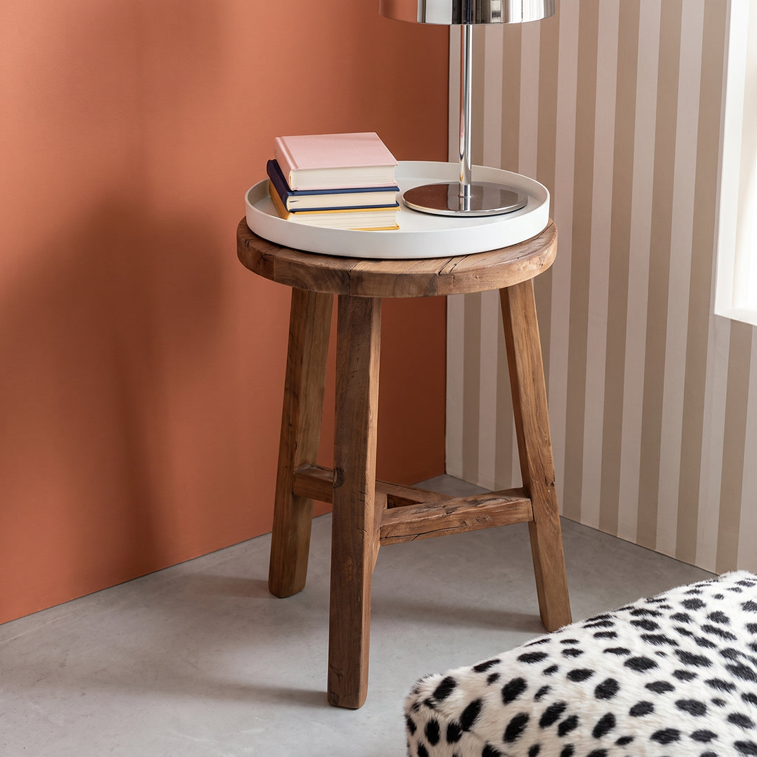 Kayu Living Farmwood stool made from reclaimed brown wood with a white tray top holding books and a lamp