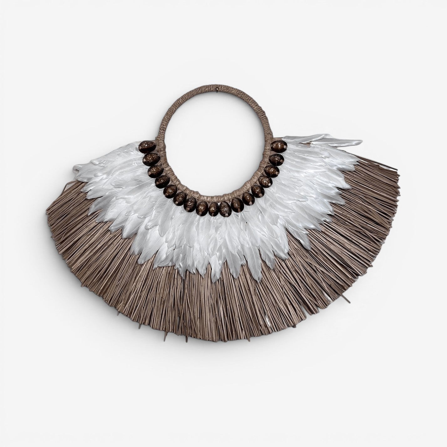 Kayu Living Flores Harmony wall decoration with woven fibers, white feathers, and brown shells.