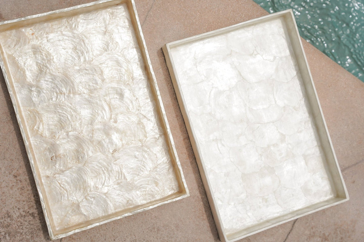 Two rectangular Kayu Living Capiz shell plates with a lustrous gold finish, handmade decorative trays for home decor.