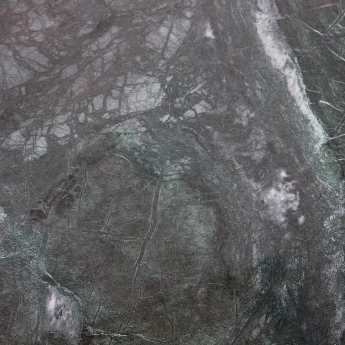 Close-up of Kayu Living green marble coffee table surface showing unique white veining and natural stone texture