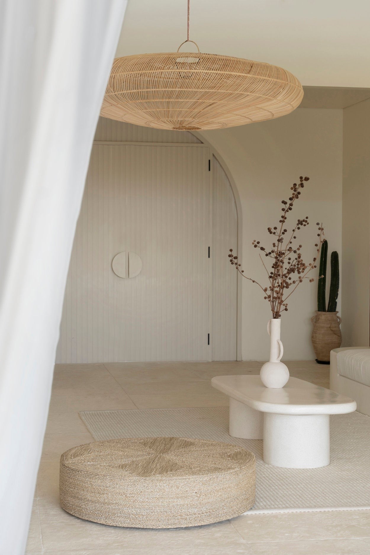 Kayu Living The Huge Pouf, a 100cm handcrafted natural seagrass floor cushion with a textured woven pattern.