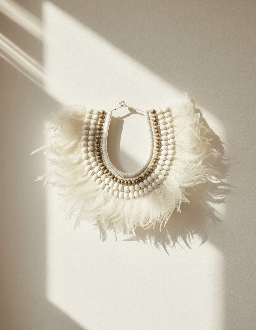 Kayu Living Ivory white feather necklace with natural shells and beads, handcrafted bohemian wall decor.