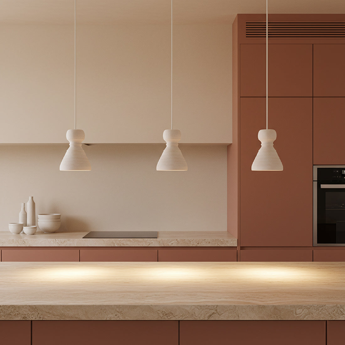 Kayu Living Kanoi pendant lamp trio in matte chalky Ecomix, featuring organic stone-like shapes in a modern kitchen.