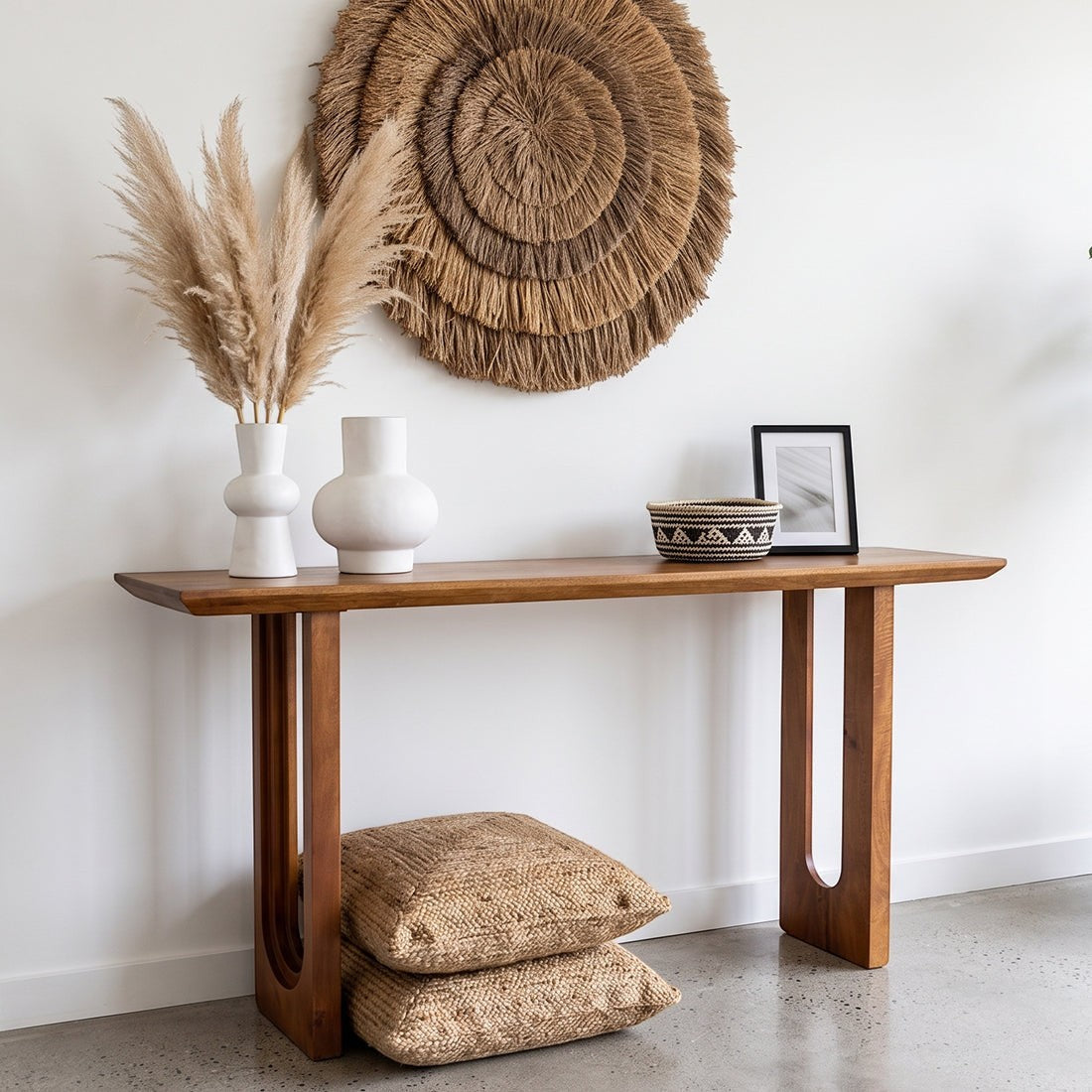 Kayu Living solid mango wood console table with chamfered edges, styled with vases and baskets in a bright hallway.
