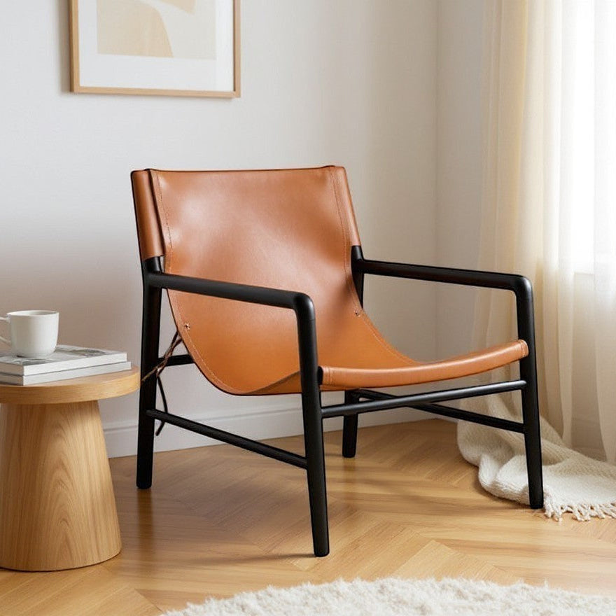 Kayu Living Marita lounge chair in cognac leather with black frame. Modern armchair for living room.