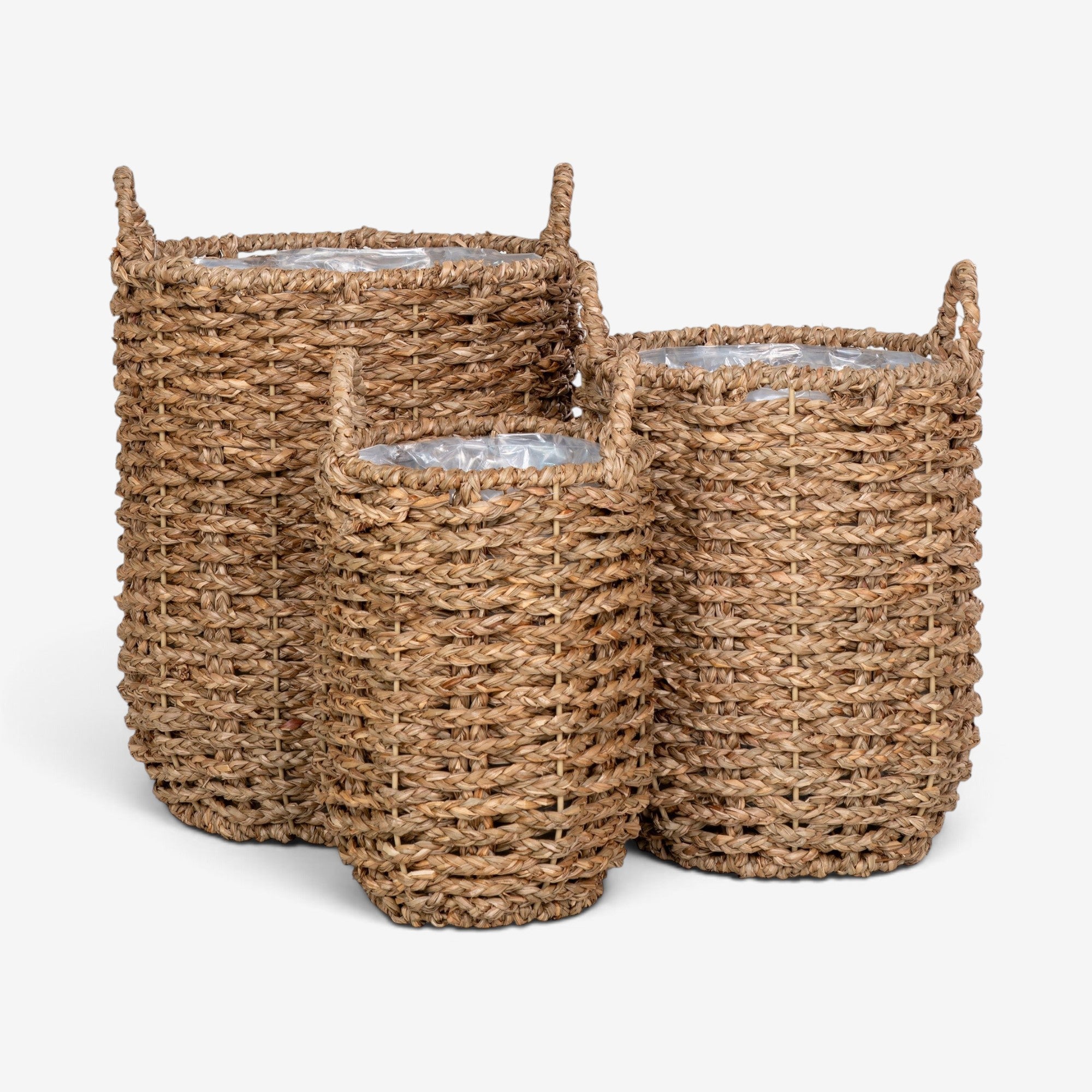 Kayu Living set of three natural seagrass storage baskets with woven texture and integrated handles