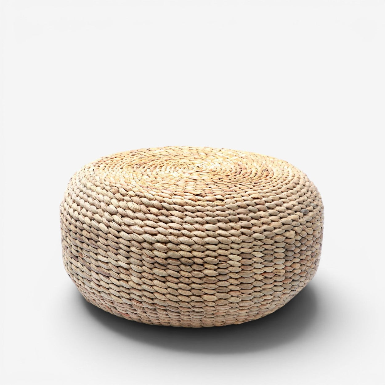 Kayu Living handcrafted natural water hyacinth round pouf with organic woven texture for living room decor.