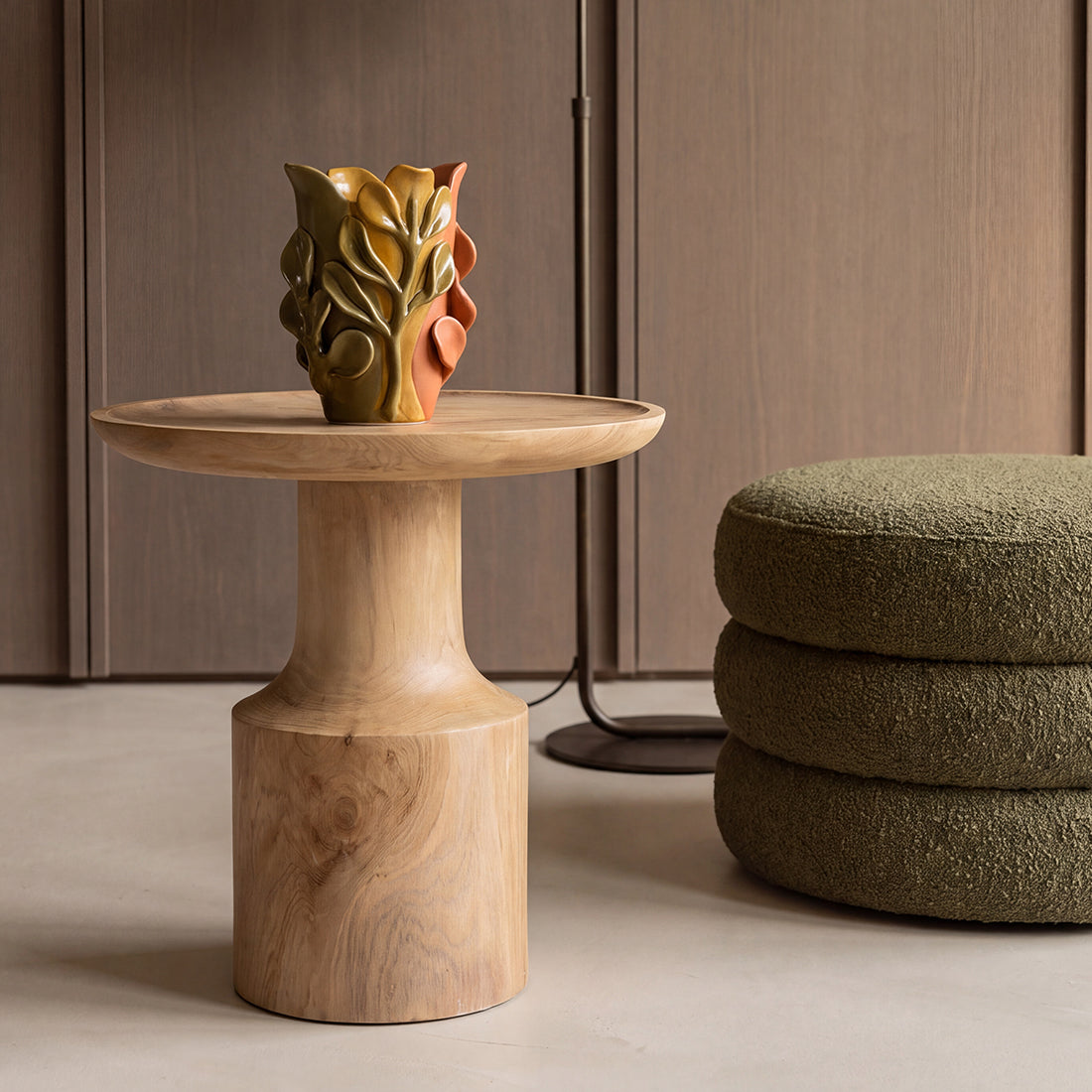 Kayu Living Nero Day side table in natural teak wood with a modern pedestal base and a decorative ceramic vase