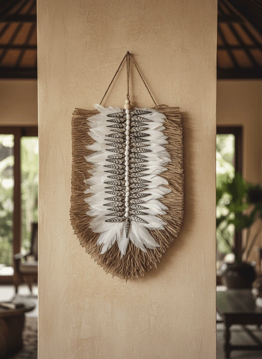 Kayu Living Nias feather and shell wall decoration with natural fibers and white feathers.