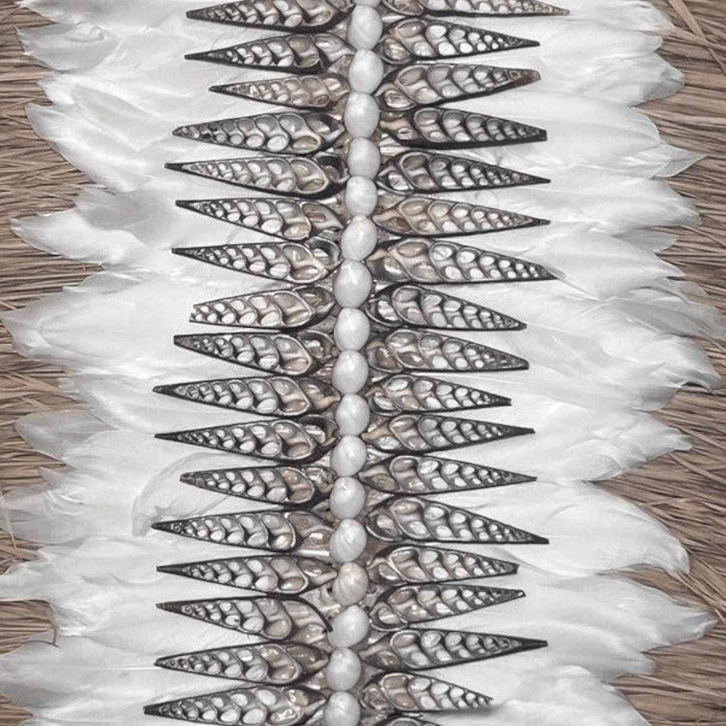 Kayu Living Nias feather and shell wall decoration with white feathers and natural shells.