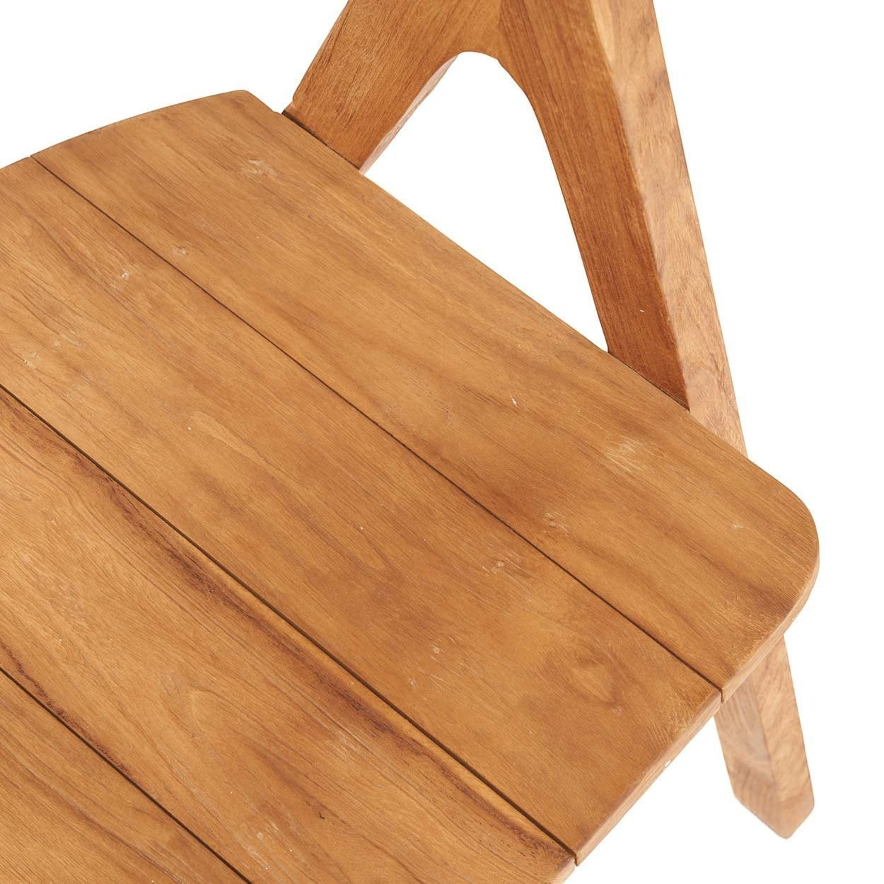 Kayu Living Nihi Sumba outdoor dining chair made of natural teak with sculpted curves and crisp lines.