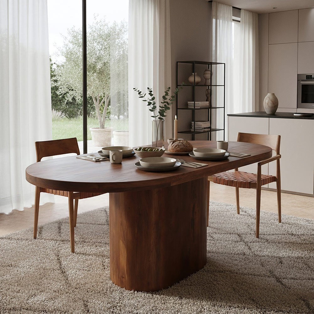 Kayu Living bullnose oblong oval dining table in solid mango wood with a central pedestal base in a modern kitchen.