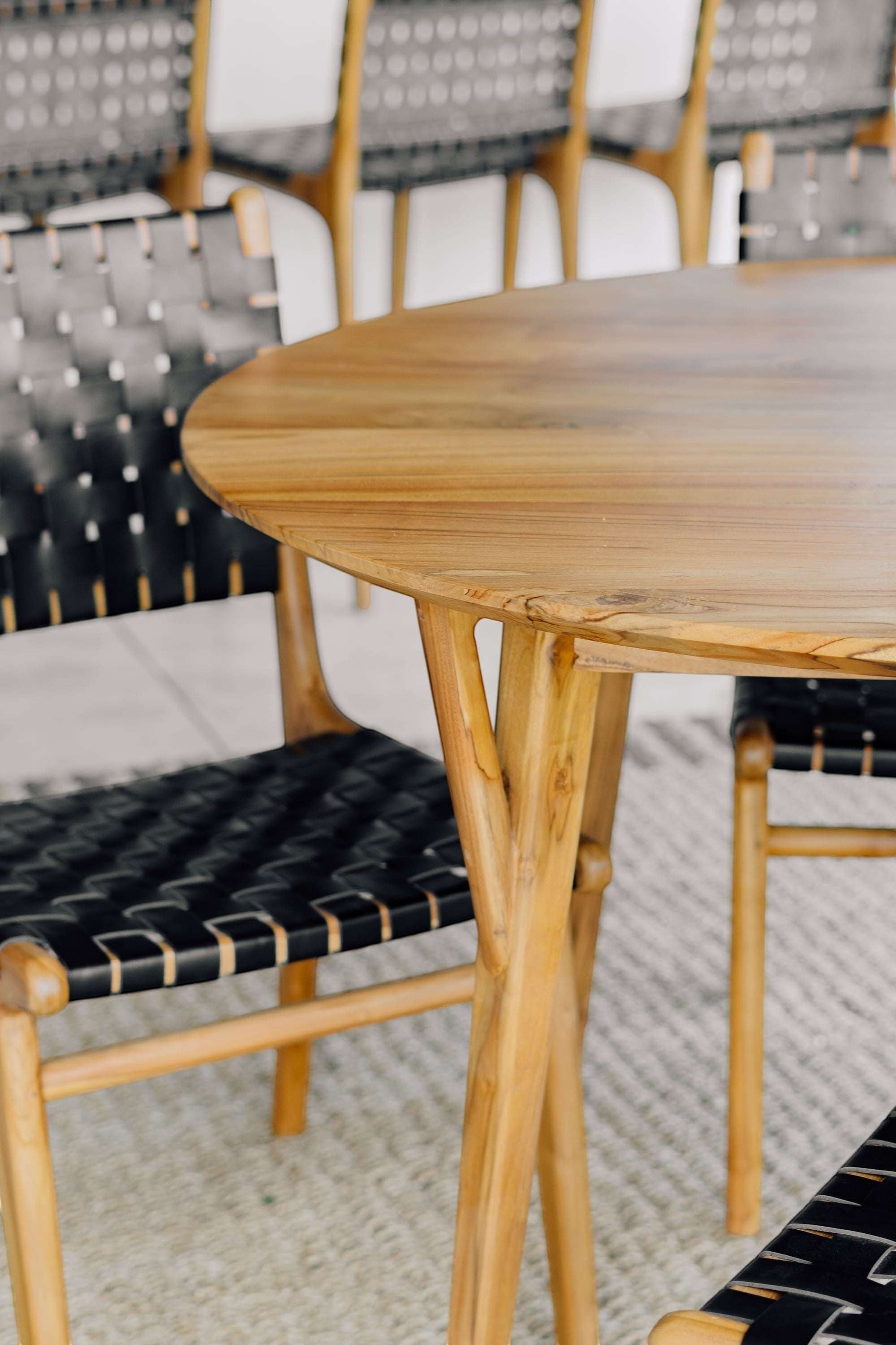 Kayu Living Pantai round 120 cm teak dining table with natural wood grain and unique artisan craftsmanship.