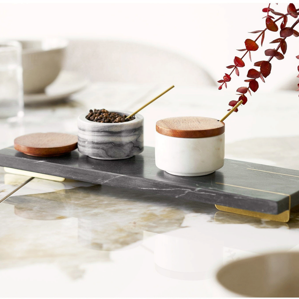 Kayu Living Pauri marble storage jars with wooden lids and brass spoons on a matching grey marble serving tray