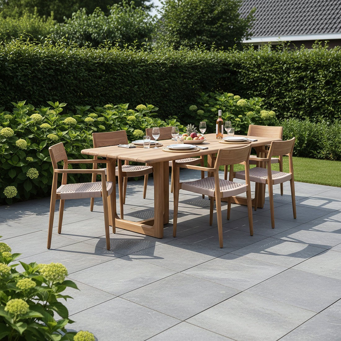 Kayu Living Primavera 200cm teak garden table with rounded edges and U-shaped legs on a stone patio.
