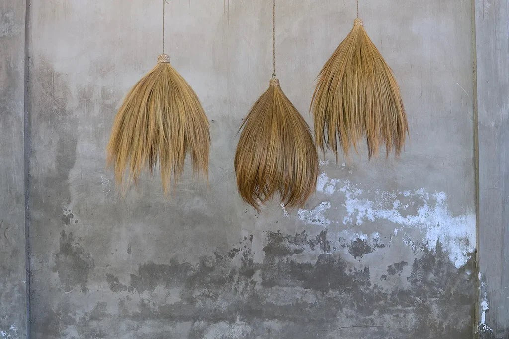 Kayu Living Rayung pendant lamp made from natural rayung grass, featuring a flowing silhouette and organic texture in warm, natural tones.