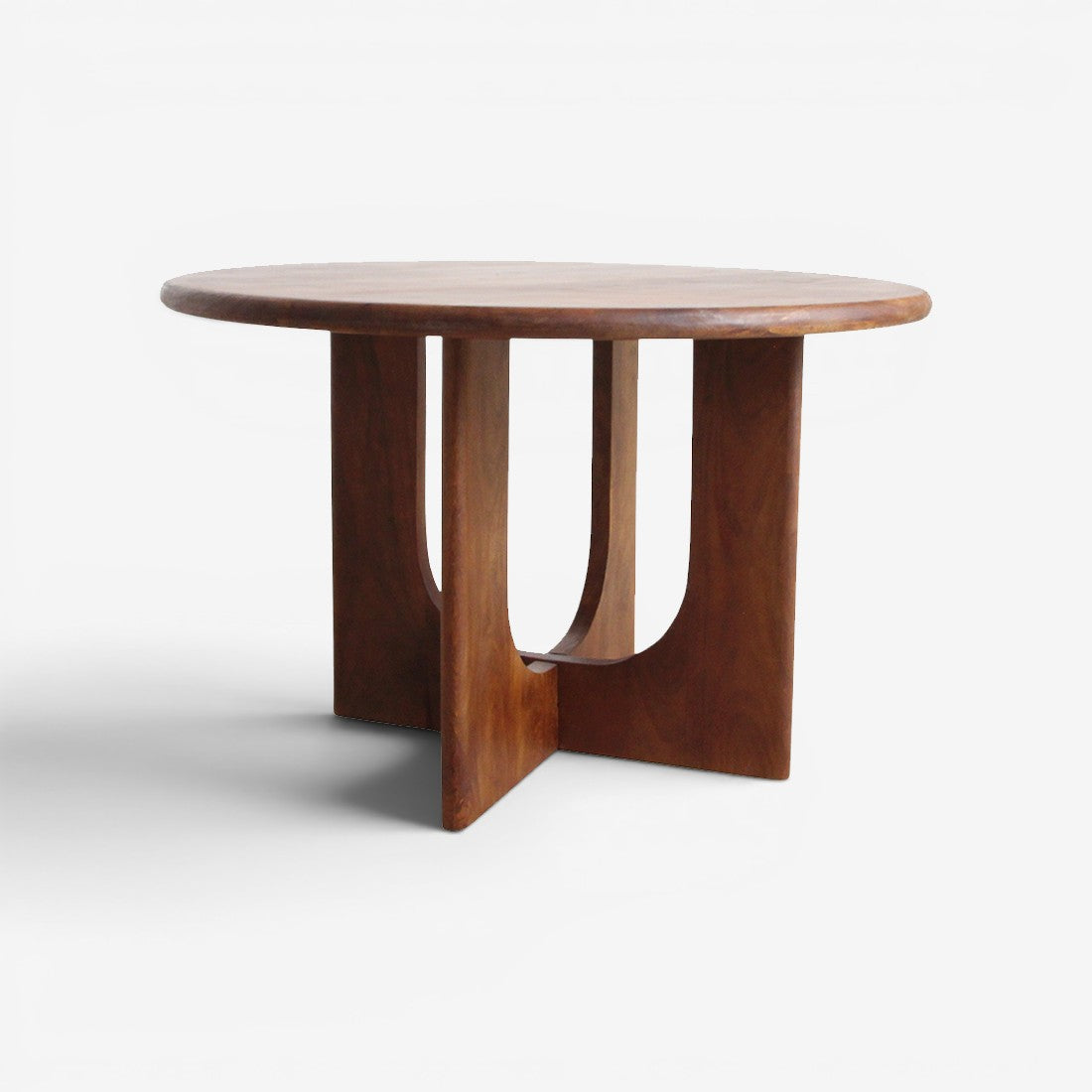 Kayu Living round Bullnose Coliseo dining table in solid mango wood with a robust cross-shaped base and natural grain.