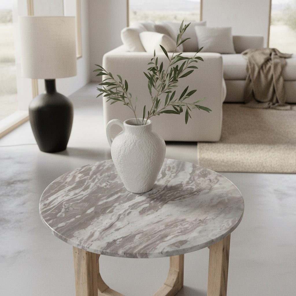 Kayu Living round Fantasy Brown marble side table with mango wood base, styled with a white vase in a living room.