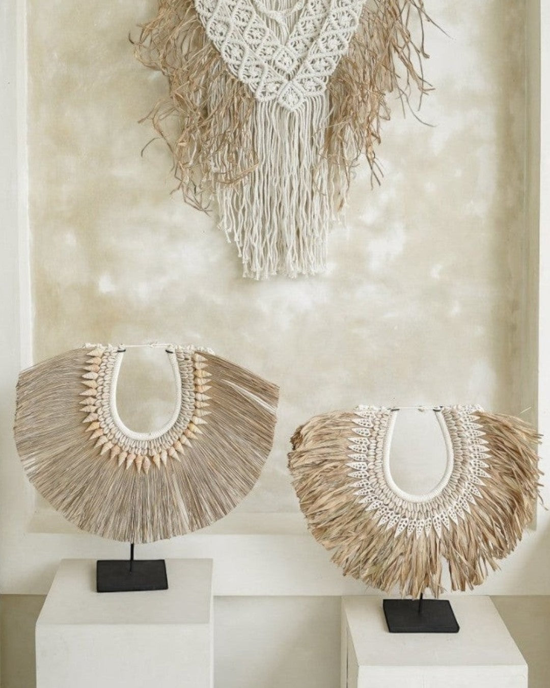 Kayu Living handmade seagrass and shell decor on stands with a matching macrame wall hanging in neutral tones.