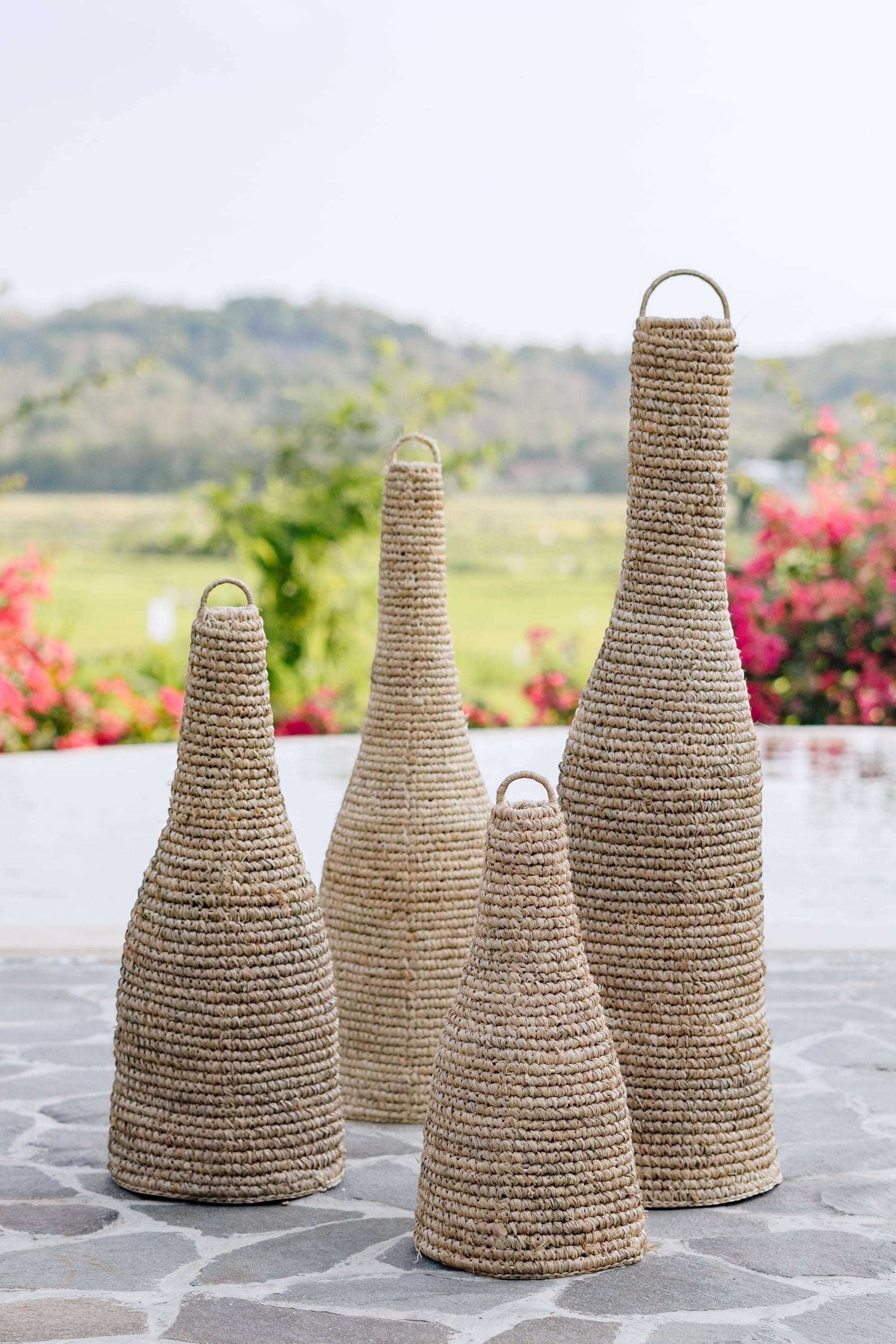 Kayu Living natural sisal pendant lampshade in a tapered bottle shape with a loop handle. Available in multiple sizes.