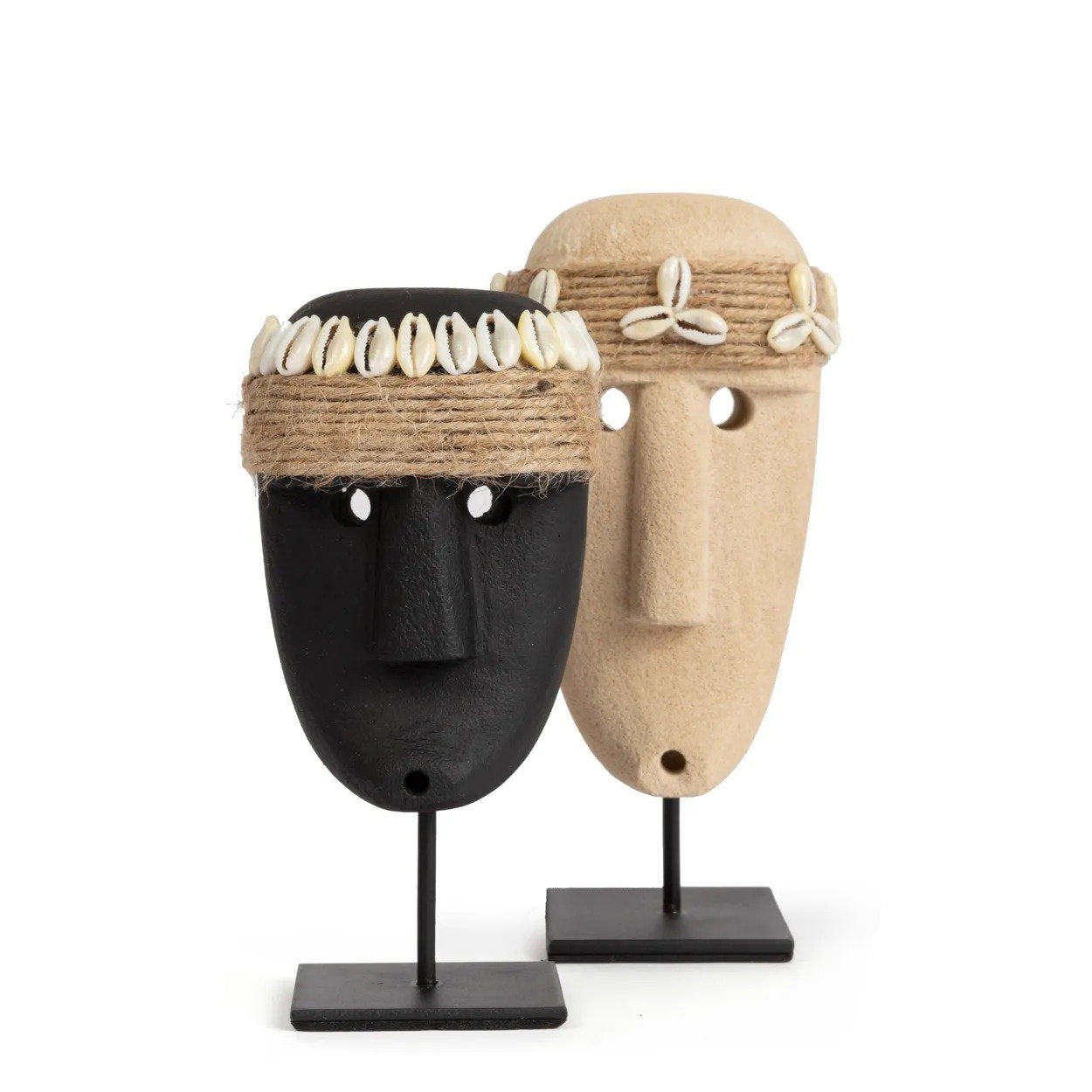 Kayu Living hand-carved sandstone Sumba figures on stands, one black and one natural stone with shell and rope accents.