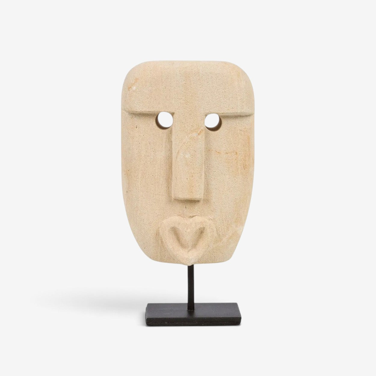 Kayu Living hand-carved sandstone Sumba stone statue with a heart-shaped mouth on a black metal display stand.