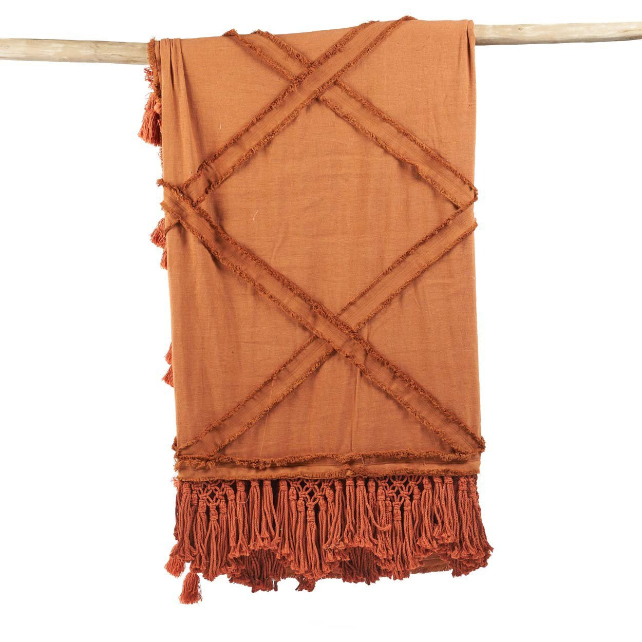 Kayu Living terracotta cotton throw with a textured plaid design and decorative fringe tassels hanging on a branch.