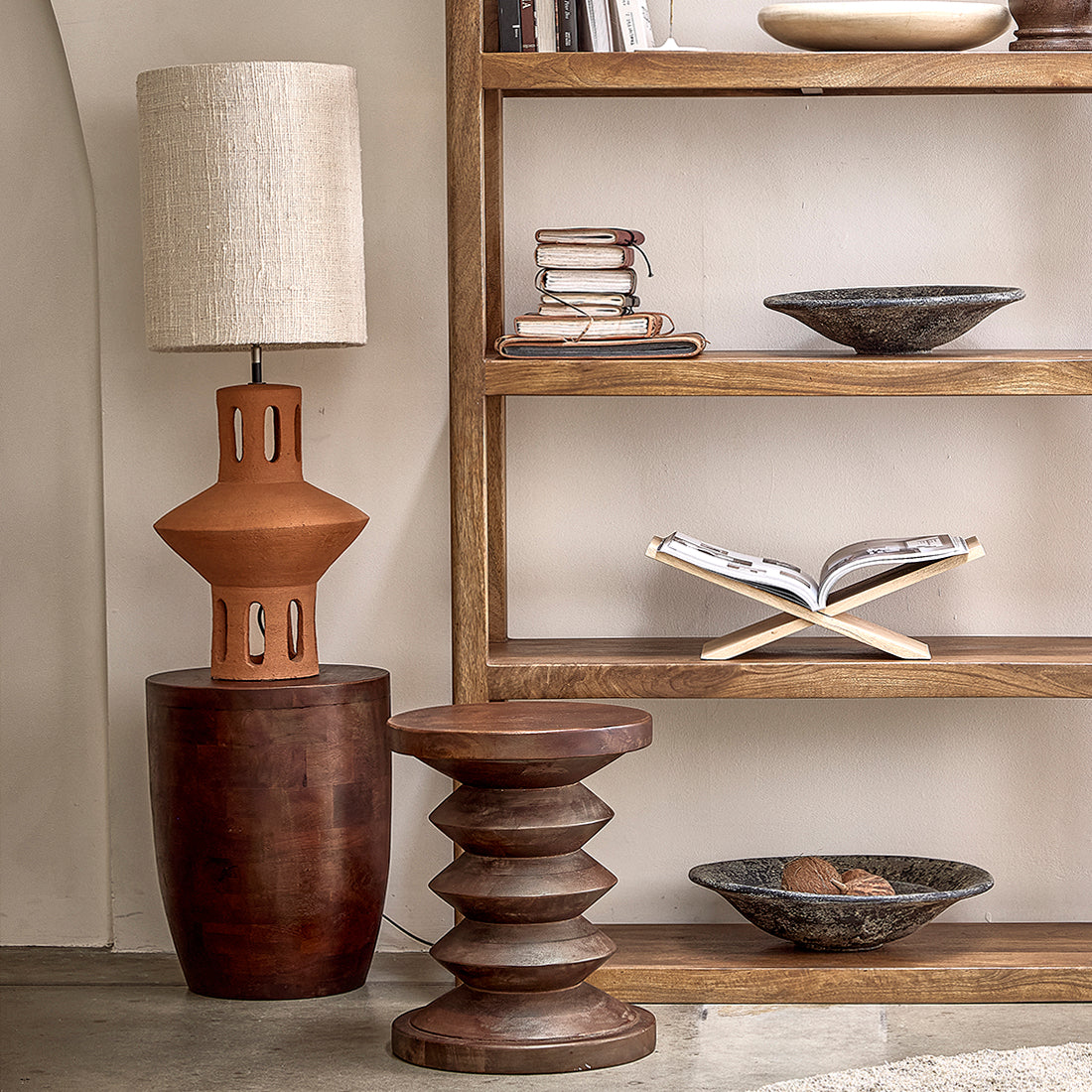 Kayu Living Tuvalu mango wood stool with a unique tiered design, placed in a warm, bohemian-style living room.