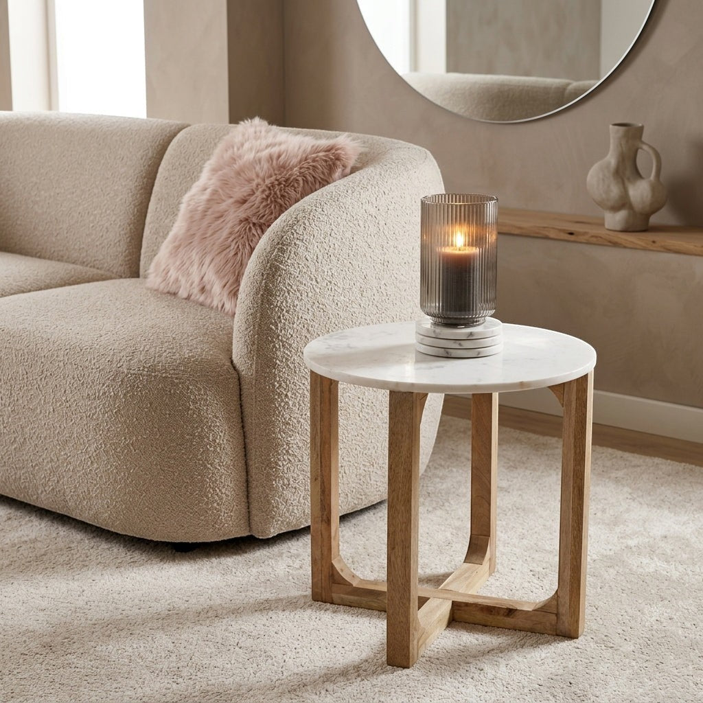 Kayu Living white marble side table with a solid mango wood cross-shaped base in a cozy living room setting.