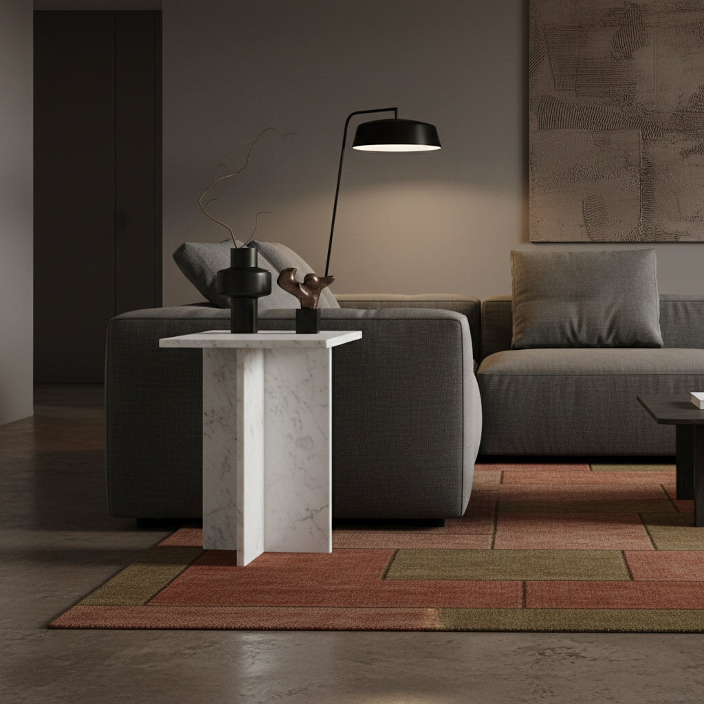 Kayu Living white marble side table with crossed slab base, placed in a modern living room next to a grey sofa.