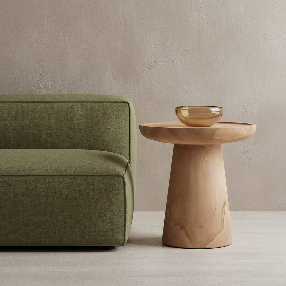 Nero Ray teak side table by Raw Materials, showcasing a sleek, modern wooden surface with tapered legs on a neutral background.