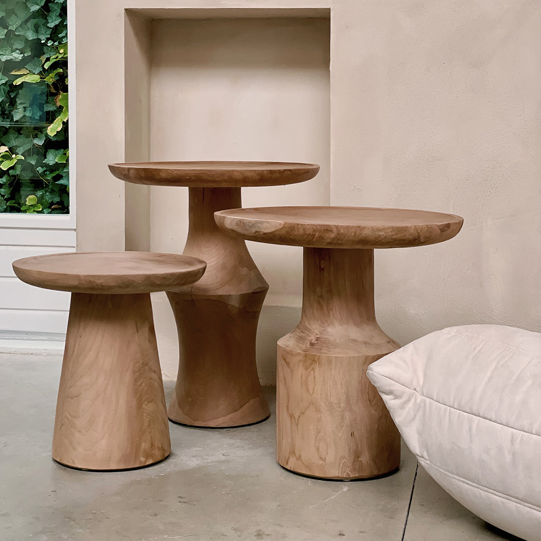 Raw Materials Nero Ray teak side table with sleek design and natural wood finish, perfect for modern living spaces.