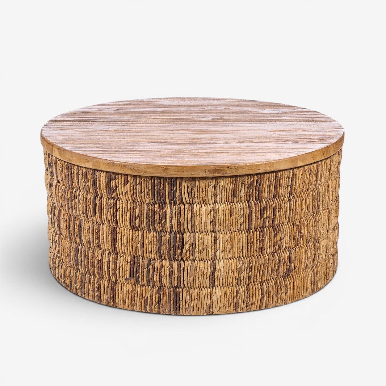 Kayu Living round coffee table with a natural teak wood top and handwoven abaca fiber base in a warm, textured finish.
