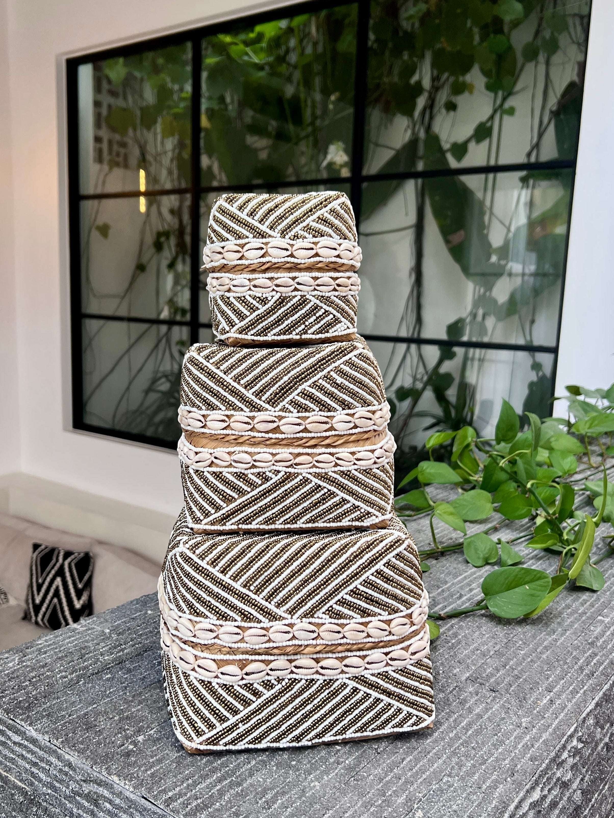 Kayu Living handmade beaded boxes in gold, white, and natural shells. Decorative storage for home decor.