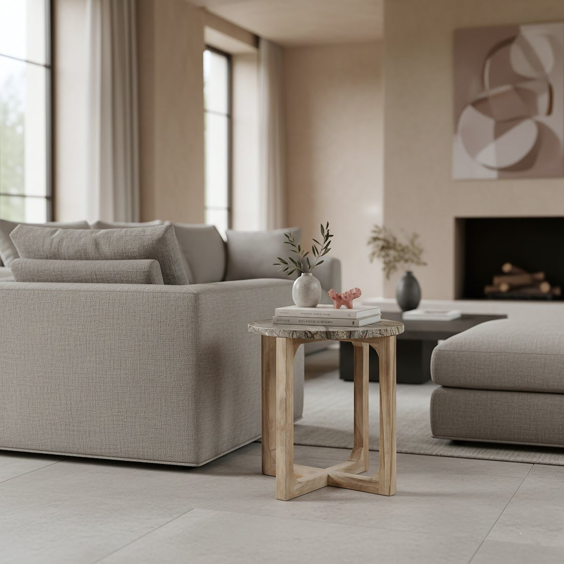 Kayu Living Bizar side table with a round marble top and crossed mango wood base in a modern living room setting.